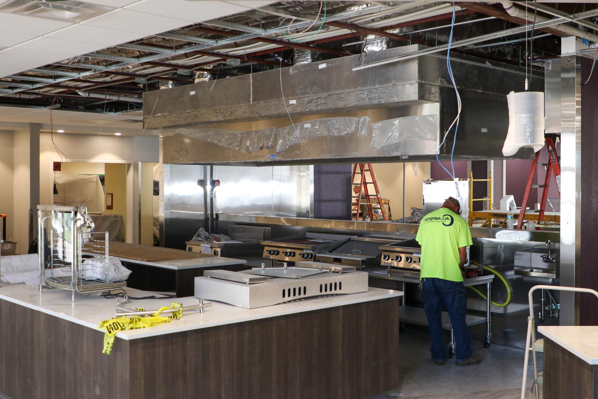 Men working indoors on construction, dining items around them